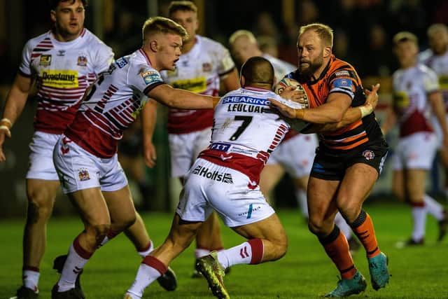 Paul McShane is tackled by Thomas Leuluai during Tigers' win over Wigan last season. Picture by Bruce Rollinson.