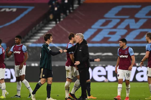 SETBACK: Leeds United's Spanish international defender Diego Llorente interacts with West Ham boss David Moyes after Monday night's 2-0 defeat at the London Stadium. Photo by Andy Rain - Pool/Getty Images.