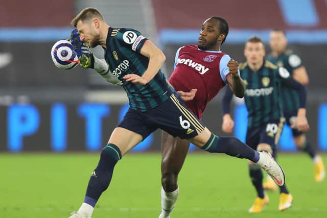 CAPITAL PUNISHMENT: Leeds United captain Liam Cooper challenges the high boot of West Ham striker Michail Antonio in Monday night's 2-0 defeat at the London Stadium. Photo by JULIAN FINNEY/POOL/AFP via Getty Images.