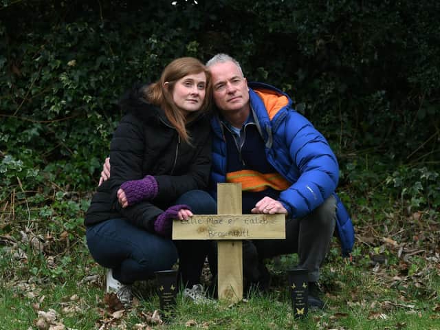 Lynsey Dent and her husband Chris, pictured at the grave of her children Ellie Mae Brownutt and Caleb Brownutt, in the graveyard of St Chad's Parish Church in Headingley.
Picture : Jonathan Gawthorpe