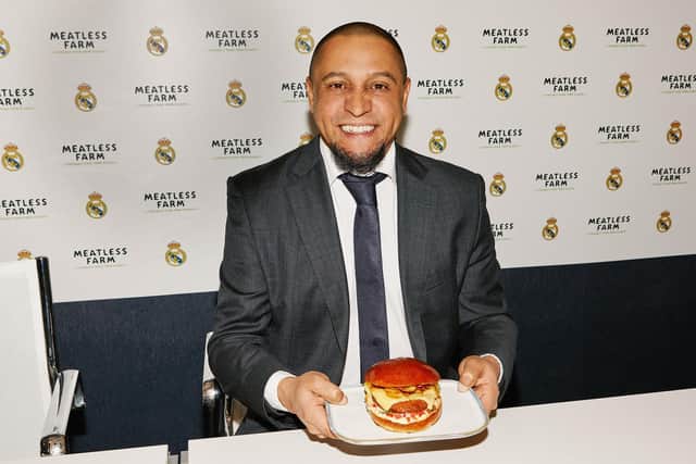 Real Madrid legend and football ambassador Roberto Carlos with a plant-based Meatless Farm burger