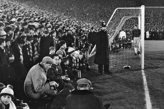 RECORD CROWD: Fans watch from the edge of the Elland Road pitch as Leeds United take on Sunderland in the FA Cup replay of March 1967. Picture by Varleys.
