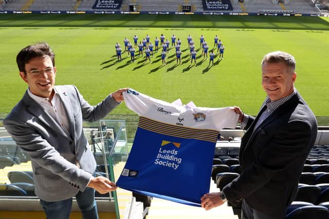 Leeds Building Society chief executive Richard Fearon, left, with Rhinos commercial director Rob Oates, in front of the - socially distanced - first team squad.