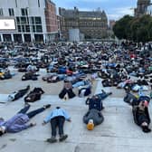 Hundreds lay on the ground at Millennium Square on Monday evening at a vigil for Sarah Everard