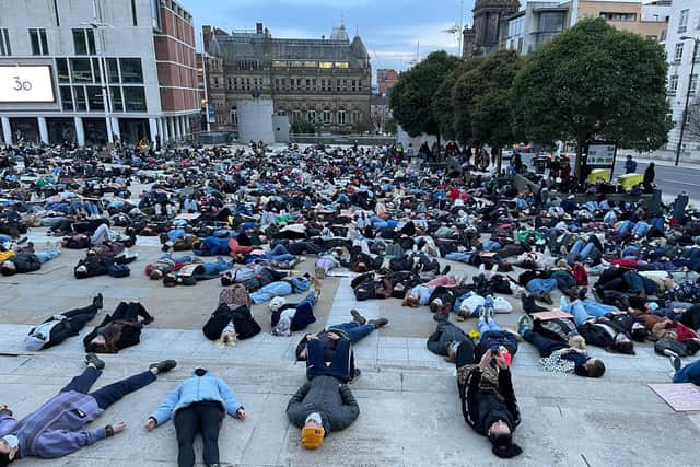 Hundreds lay on the ground at Millennium Square on Monday evening at a vigil for Sarah Everard