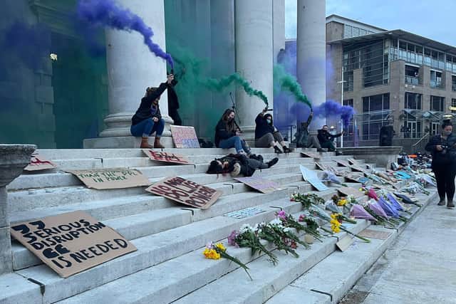 The vigil and protest concluded with handheld fountain flares omitting green and purple smoke into the air as people rose from the ground cheering and chanting as they began to leave.