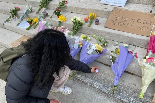People took it in turns to lay flowers and light candles to pay their respects