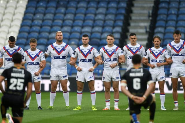 Wakefield Trinity's players stand before a game against Catalans Dragons last year. Picture by Jonathan Gawthorpe.