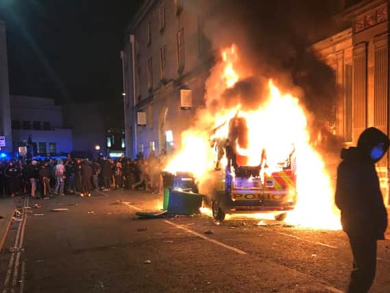 The scenes in Bristol on Sunday as police cars were set on fire and torched by pockets of the protesters. Photo: SWNS