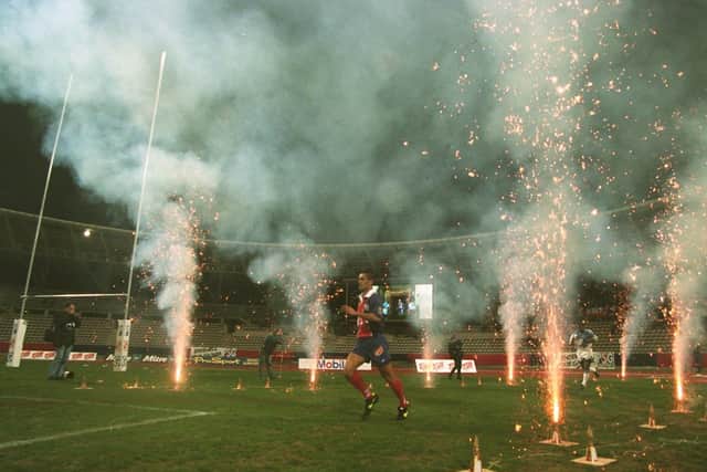 Paris St Germain and Sheffield Eagles players run through a tunnel of fireworks and enter the pitch for the start of Super League at Stade Charetly in March, 1996. Picture: Matthew Ashton/PA.