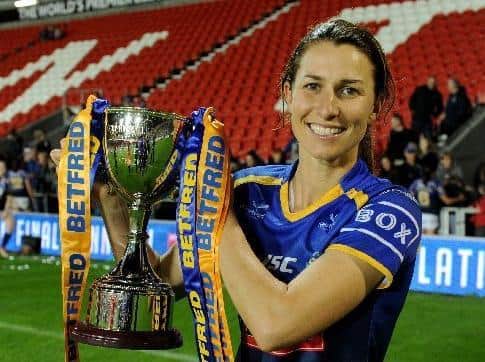 Rhinos captain Courtney Hill with the Betfred Women's Super League trophy. Picture by Steve Riding.