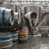 Katie Marriott pouring beer down the drain at Nomadic Beers in Leeds.