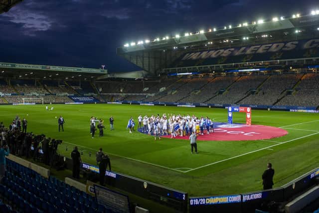 SURREAL: Leeds United celebrate with the Championship trophy in front of the empty Elland Road stands aside from the cardboard cut out crowdies following the season finale against Charlton Athletic last July. Picture by Tony Johnson.