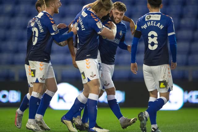 Leeds United's Alfie McCalmont (middle) celebrates with his Oldham teammates. Pic: Getty