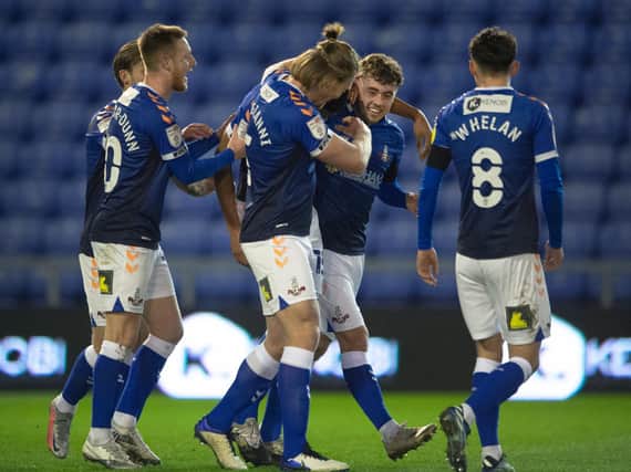 Leeds United's Alfie McCalmont (middle) celebrates with his Oldham teammates. Pic: Getty