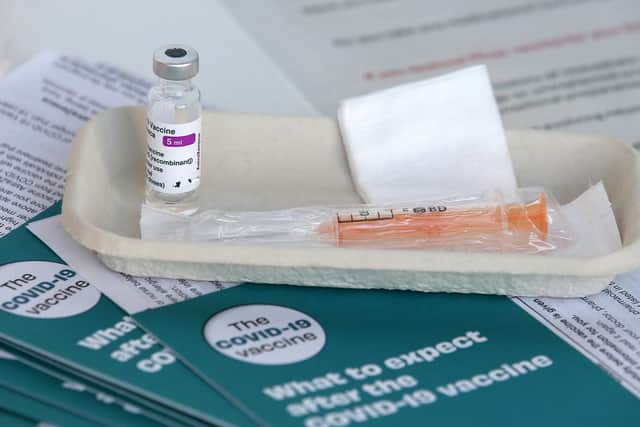 Covid-19 vaccine leaflets sit beside a vaccine vial (Photo: Andrew Milligan/PA Wire)