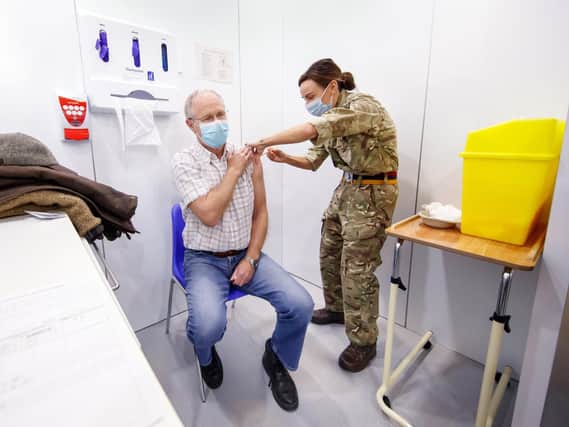 Richard Moss, 73, receives an injection of the the Oxford/AstraZeneca coronavirus vaccine from Lance Corporal Carla Fraser, Regimental Aid Post 4th Battalion Royal Regiment of Scotland, at the Elland Road vaccination centre in Leeds (photo: PA Wire/ Danny Lawson)
