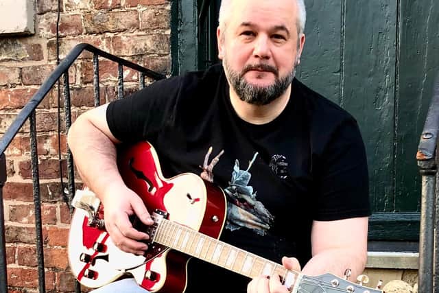 After illness forced him to leave his job, Phil Mellen has picked up his guitar and his pen again.