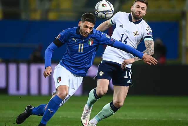 TOUGH OPENER: Leeds United's Stuart Dallas chases Italy's Domenico Berardi during Northern Ireland's 2-0 defeat in Thursday night's World Cup qualifier in Parma. Photo by MARCO BERTORELLO/AFP via Getty Images.