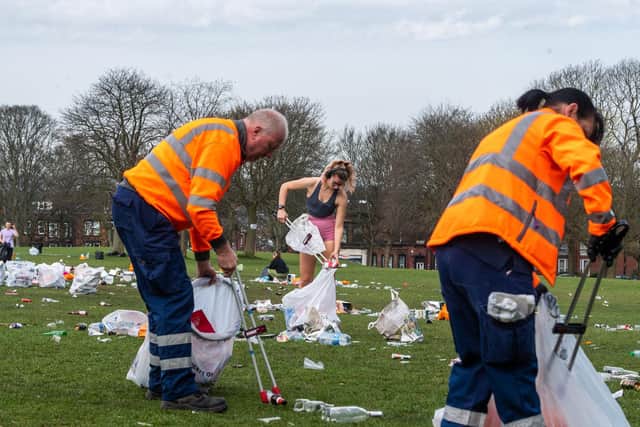 Massive clean-up operation by some students, residents and Leeds City Council on Woodhouse Moor, Headingley, Leeds, after hundreds of people gathered on TUeaday to enjoy the warm weather and into the evening resulting in leaving behind tons of litter, bottles, food, disposable barbecue and hundreds of used nitrous oxide canisters (laughing gas).
