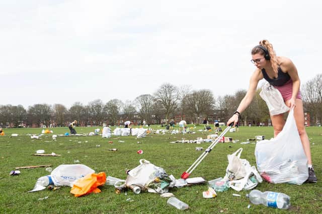 A woman helps to clear away rubbish on Woodhouse Moor (photo: SWNS).
