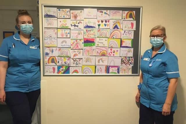 Two members of the team at Sue Ryder Wheatfields Hospice in Headingley with the colourful 'positivity postcards' that arrived in the post.