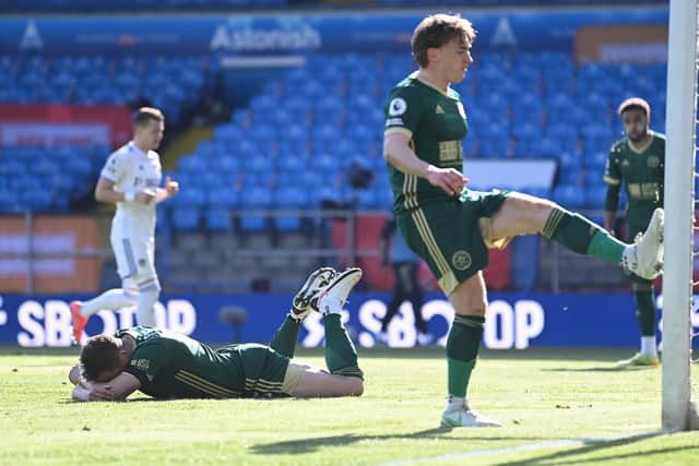 FRUSTRATION: Sheffield United's Ben Osborn, right, kicks the post after an own goal from Phil Jagielka, left, puts Leeds United back in front at Elland Road. Photo by Laurence Griffiths/Getty Images.