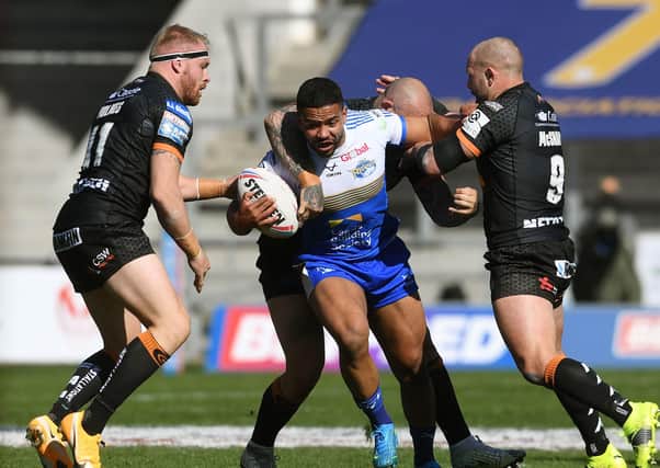 TOUGH DAY: 
Leeds Rhinos' Kruse Leeming finds his path blocked by Castleford Tigers at the TW Stadium. 
Picture: Jonathan Gawthorpe