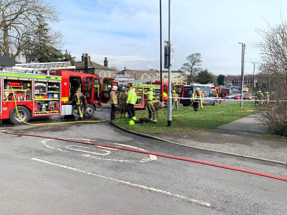 Five engines are tackling a large house fire on a main Leeds road.