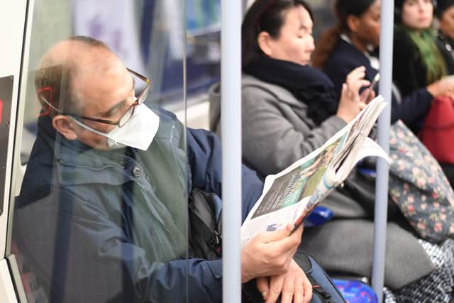A man on the Jubilee line on the London Underground tube network wearing a protective facemask.