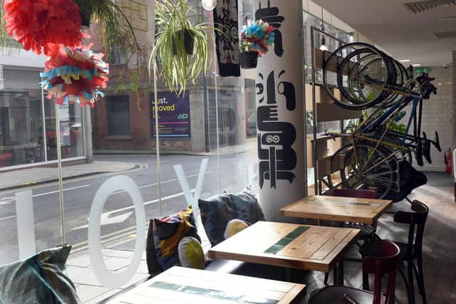 Hanging plants and artwork provides splashes of colour among the simple decor. Picture: Gary Longbottom