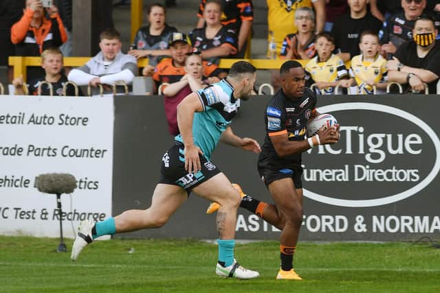 Teenager Jason Qareqare rounds Hull's Jake Connor to score 45 seconds inbto his Tigers debut last June. Picture by Jonathan Gawthorpe.