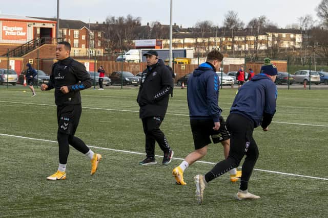 Trinity trained on the 3g pitch at Dewsbury Rams today (Thursday). Reece Lyne, left, limbers up as coach Willie Poching watches on. Picture by Tony Johnson.