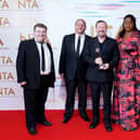 Ricky Gervais (centre) and the cast and crew of After Life in the press room after winning the Comedy award at the National Television Awards 2021.