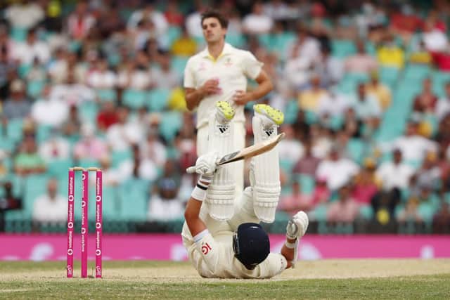 Down but not out: England's Stuart Broad after a bouncer from Pat Cummins.