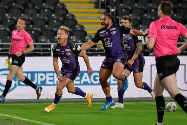 Brad Dwyer, left, celebrates a try against Hull last season. Picture by Jonathan Gawthorpe.