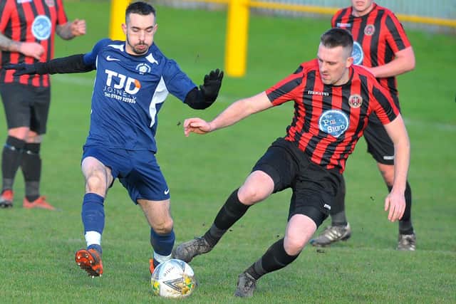 Konstantinos Katzamagkas, of Whitkirk Wanderers, goes toe to toe with Gomersal and Cleckheaton's Joel Farrar. Picture: Steve Riding.
