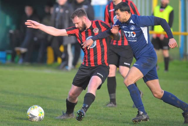 Stuart McCallum,of Gomersal and  Cleckheaton, holds off Whitkirk Wanderers' Rowan Sillah. Picture: Steve Riding.