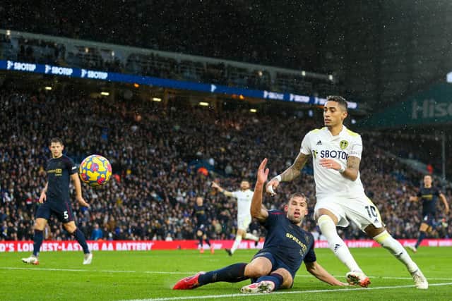 Former Whites player Charlie Taylor challenges Raphinha during Leeds United's 3-1 Premier League victory over Burnley at Elland Road on January 2. Pic: Robbie Jay Barratt.