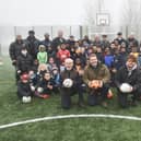 Chapeltown Juniors FC has unveiled its new artificial turf five-a-side pitch after a £24,700 donation from the North Leeds Lodge of Dawn Freemasons. Pictured at the front is Michael Rose, charity co-ordinator for Lodge of Dawn, Christian Higgins, Worshipful Master Lodge of Dawn and coach Jake Boyd