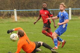 Gibril Bojang scores  for Horbury Town past Kirk Deighton goalkeeper Jonty Smith during Saturday's West Yorkshire League Premier Division encounter. Picture: Steve Riding.