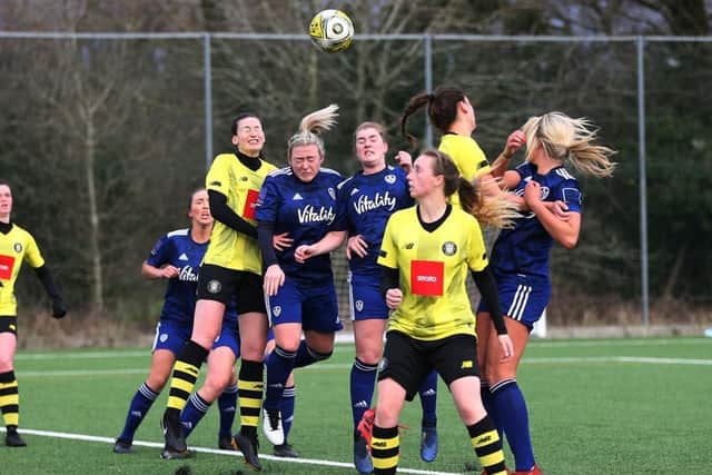 Bridie Hannon and Kirstie Hunt leap to clear the ball during Leeds United's 4-0 win over Harrogate Town. Pic: LUFC.