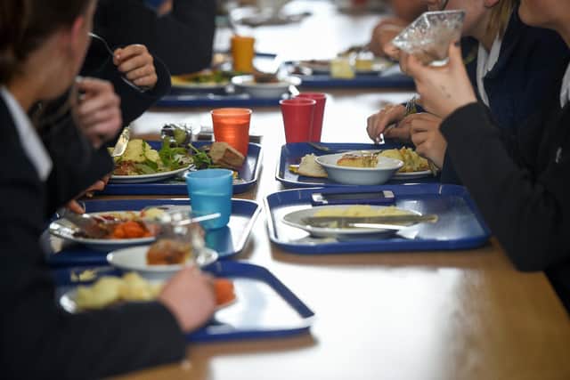 Students eating their school dinner from trays and plates during lunch. PIC: Ben Birchall/PA Wire