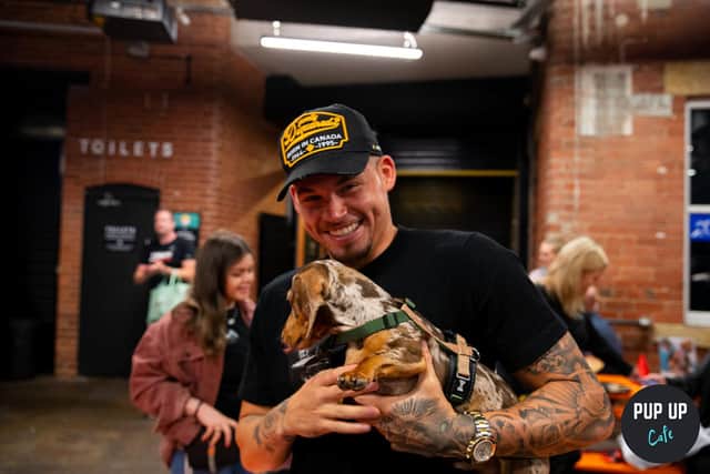 Leeds' puppy cafe is returning to Revolution Electric Press next month for a Dachshund special. Pictured is Leeds United footballer Kalvin Phillips attending the event with his dog. Photo: Pup-Up Cafe