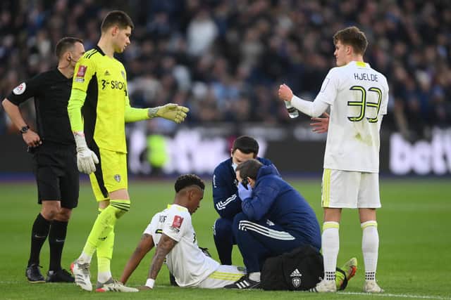 INJURY DOUBT - Junior Firpo, pictured here getting treatment for a head knock in the FA Cup at West Ham a week before limping off with a hamstring problem at the same venue, is one of several injury victims at Leeds United. Pic: Getty