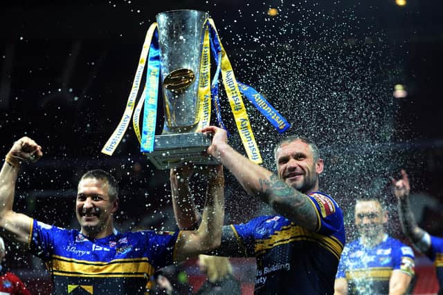 Along with Danny McGuire, Jamie Peacock, right, lifts the Super League trophy after the 2015 Grand Final, his last game for Rhinos. Picture by Jonathan Gawthorpe.