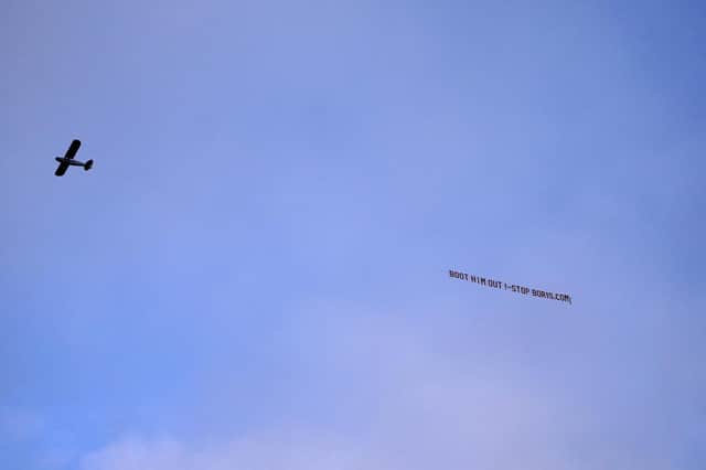 A sign protesting against British Prime Minister, Boris Johnson, is flown over at Elland Road ahead of the Premier League match between Leeds United and Newcastle United. Picture date: Saturday, January 22, 2022. PA.