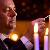 The Holocaust Memorial service at Leeds City Varieties..Master of the Ceremony Geoff Turnbull lights a candle.

Photo: Simon Hulme