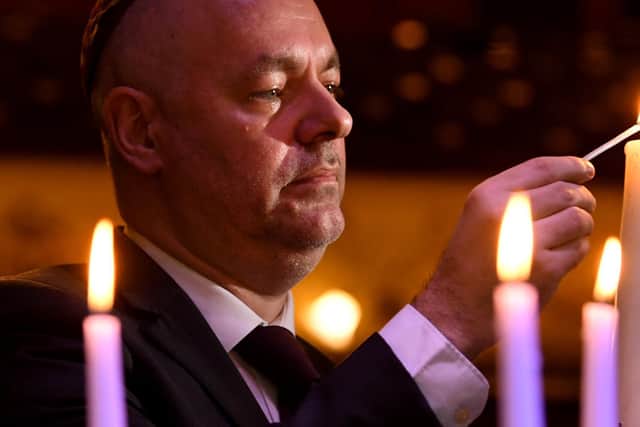 The Holocaust Memorial service at Leeds City Varieties..Master of the Ceremony Geoff Turnbull lights a candle.

Photo: Simon Hulme