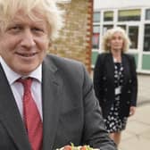 In this Downing Street handout photograph dated 19/6/2020 Boris Johnson holds up a birthday cake - baked for him by school staff - during a visit to Bovingdon Primary Academy.